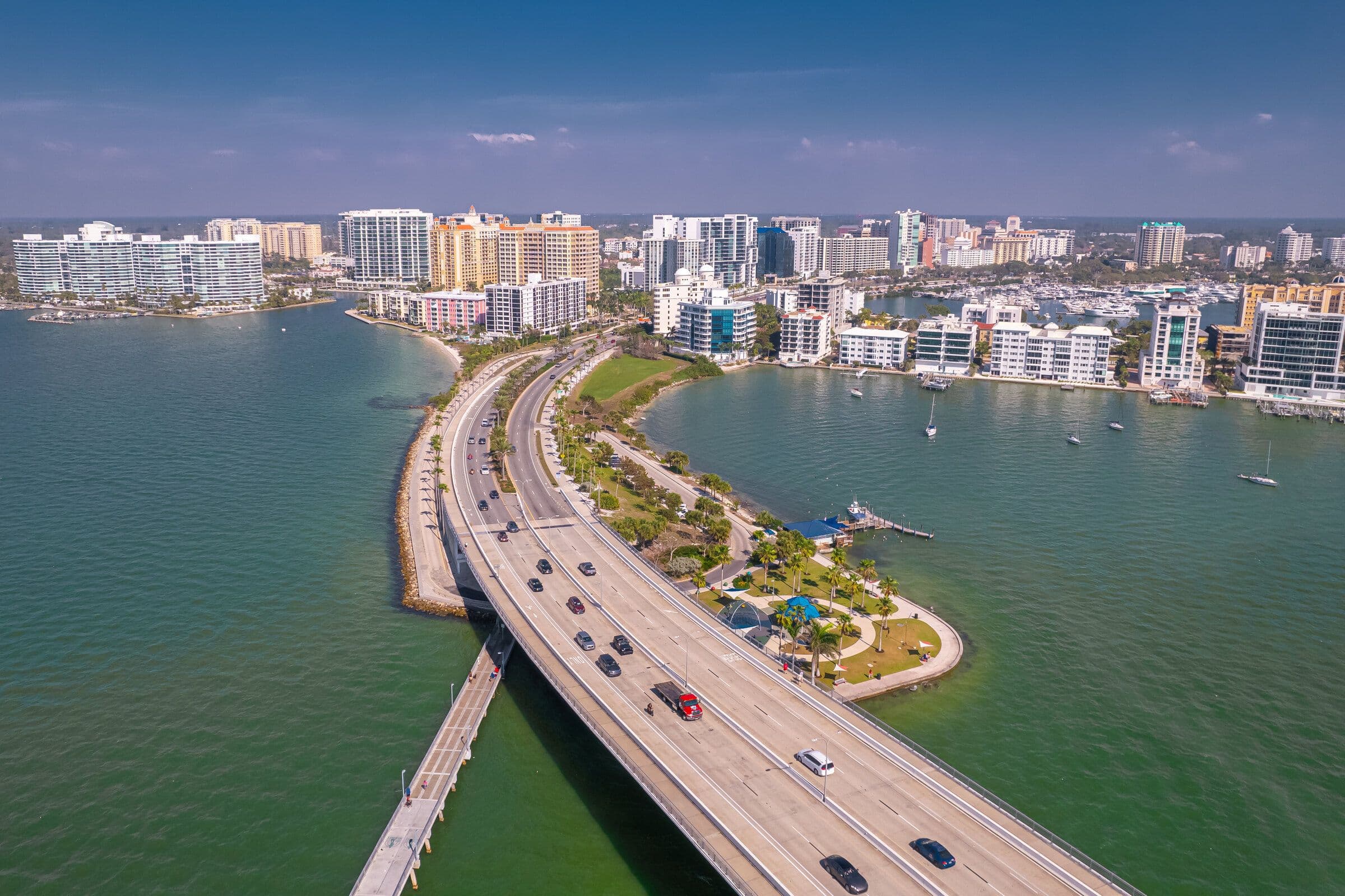 Aerial view of the causeway crossing Sarasota Bay with the city skyline behind it