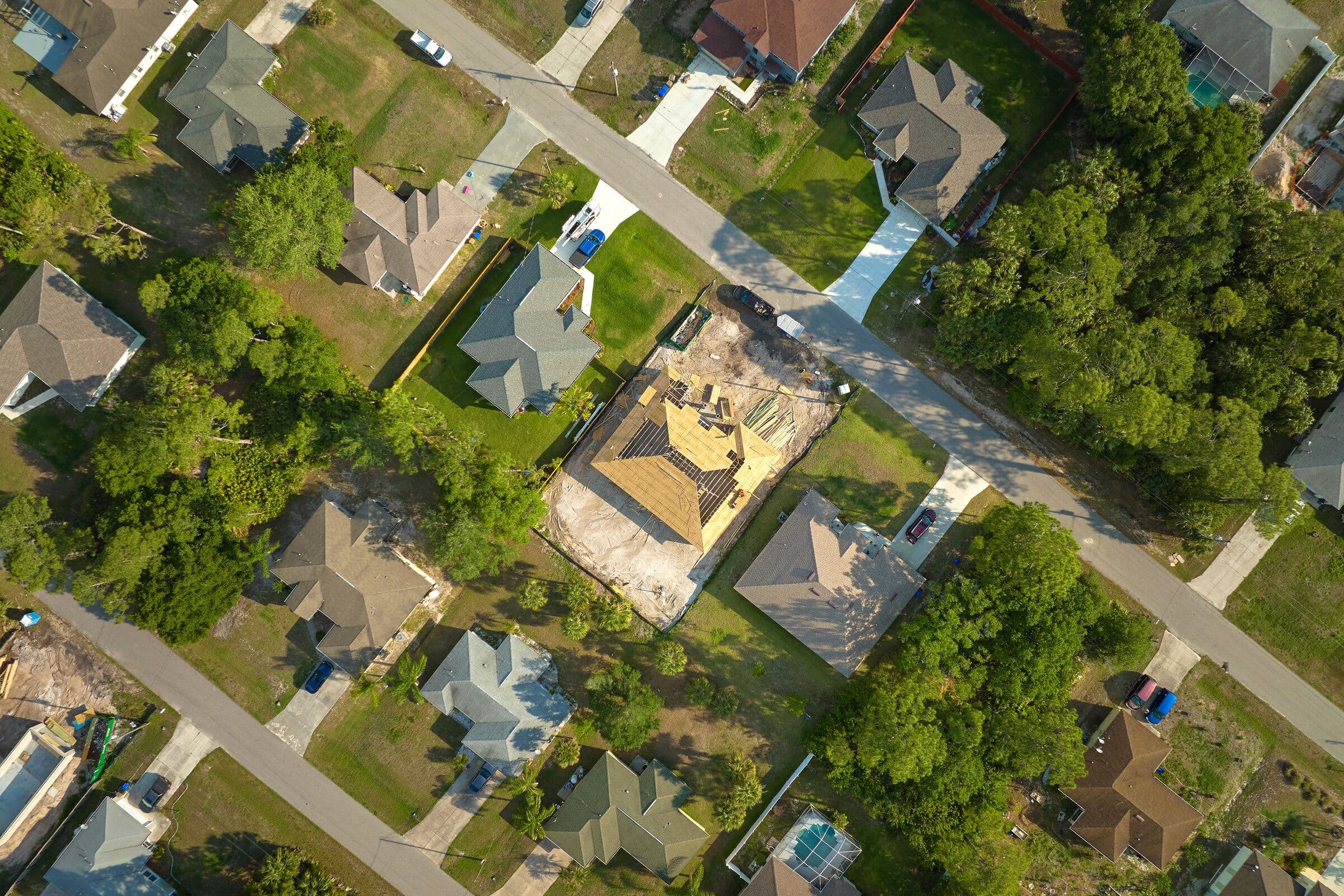 Aerial view of a Florida subdivision with houses at several stages of construction